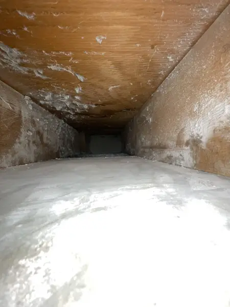 Inside view of an air duct with heavy dust buildup